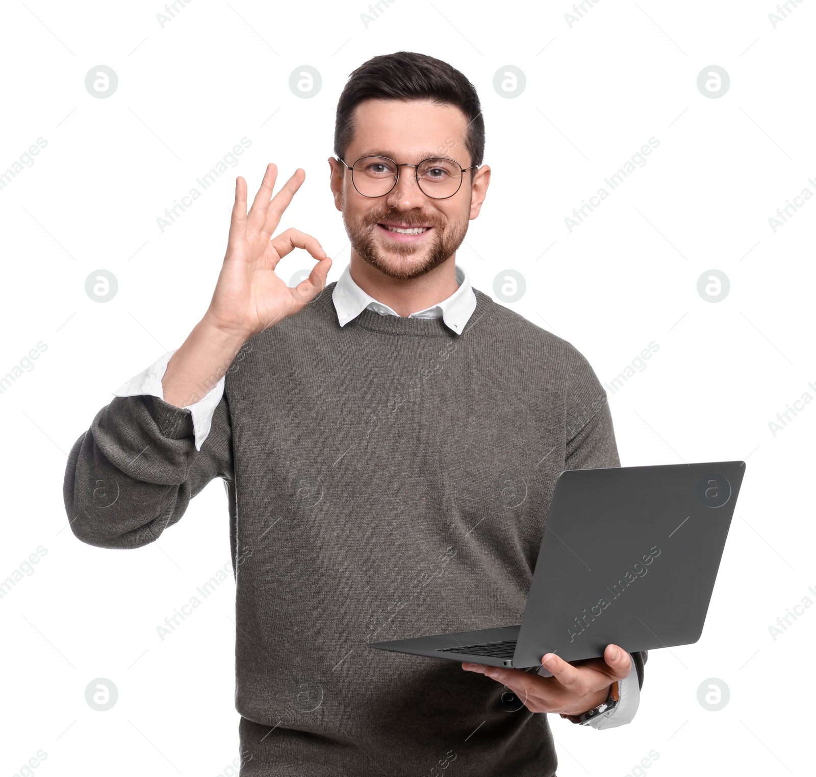 Photo of Handsome bearded businessman with laptop showing OK gesture on white background