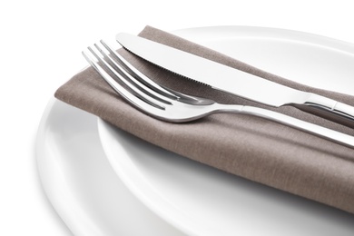 Plates with clean cutlery and napkin isolated on white