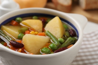 Photo of Bowl of delicious turnip soup on table, closeup view