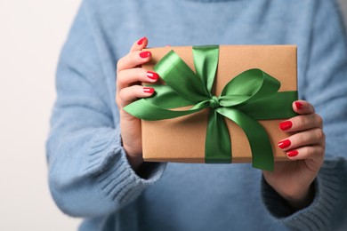 Photo of Christmas present. Woman holding gift box on white background, closeup