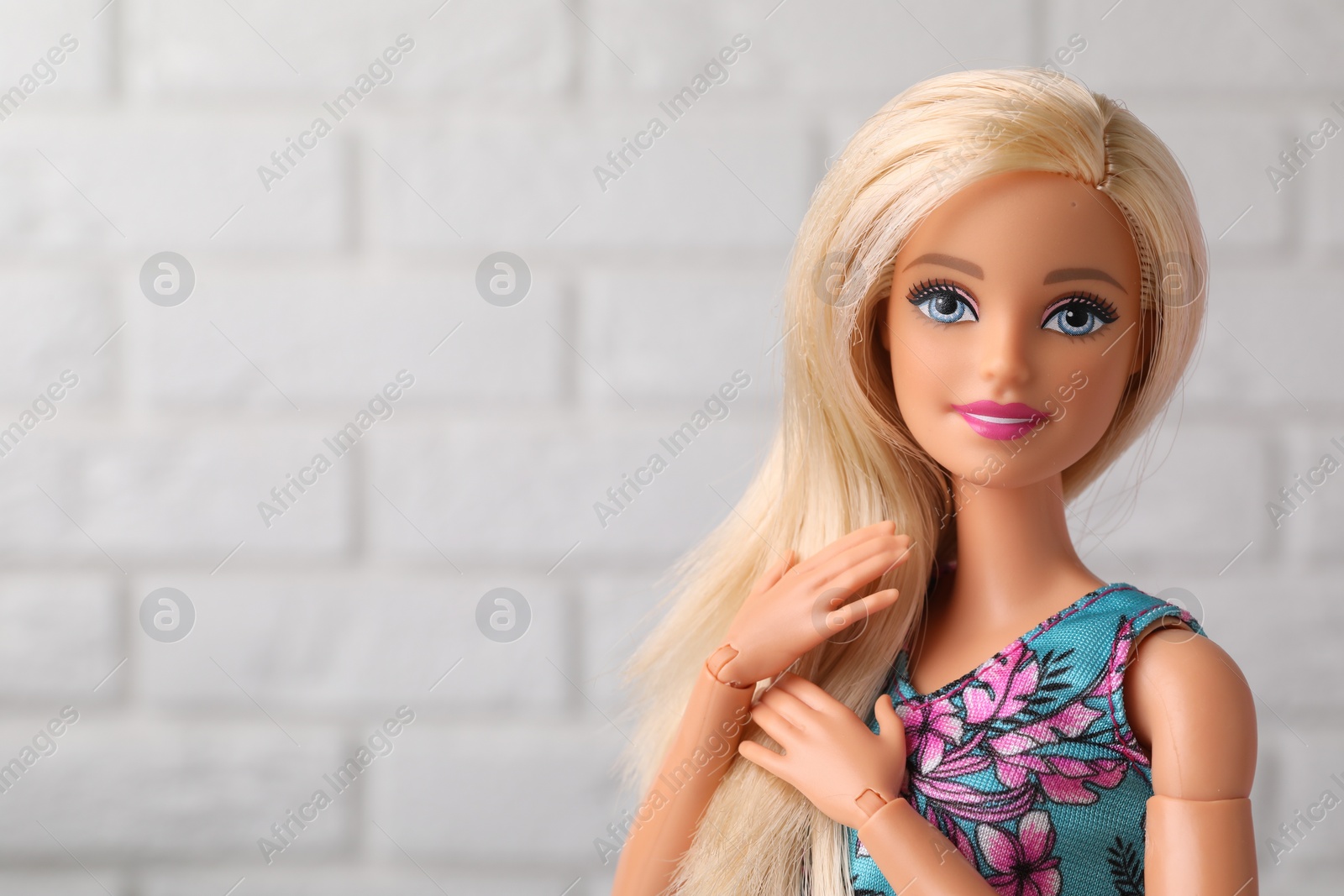 Photo of Mykolaiv, Ukraine - September 4, 2023: Beautiful Barbie doll near white brick wall, space for text