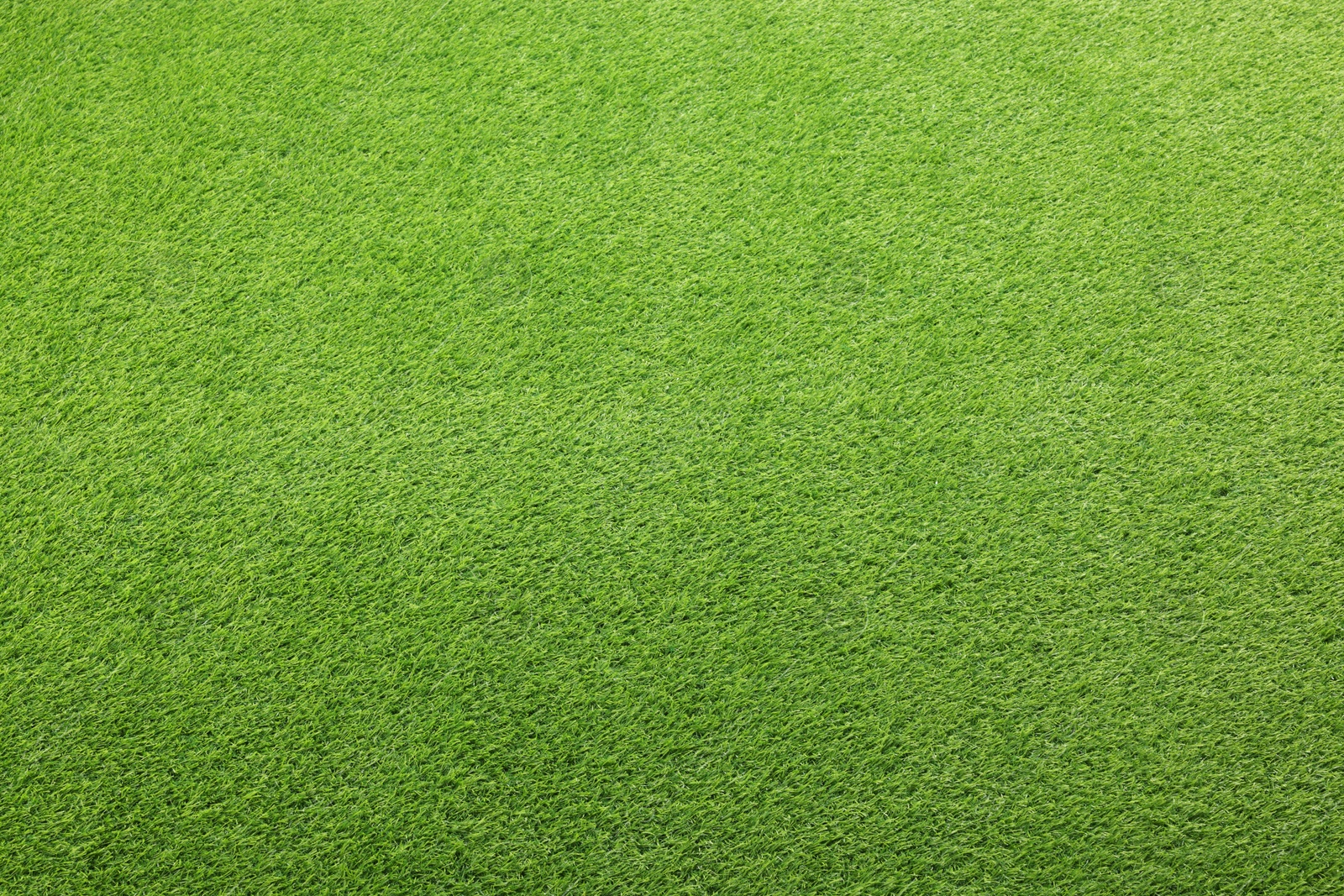 Photo of Green artificial grass as background, top view