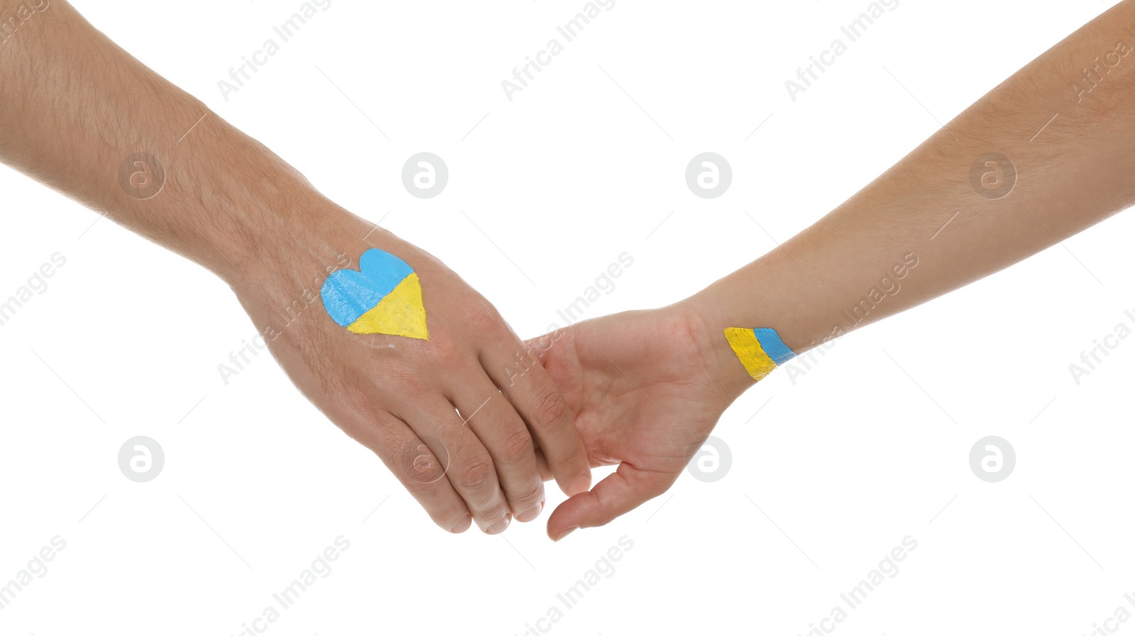 Photo of Man and woman with painted Ukrainian flags on their hands against white background, closeup