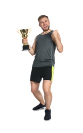 Photo of Full length portrait of happy young sportsman with gold trophy cup on white background