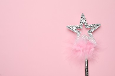 Photo of Beautiful silver magic wand with feather on pink background, top view. Space for text