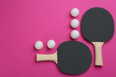 Ping pong rackets and balls on pink background, flat lay. Space for text