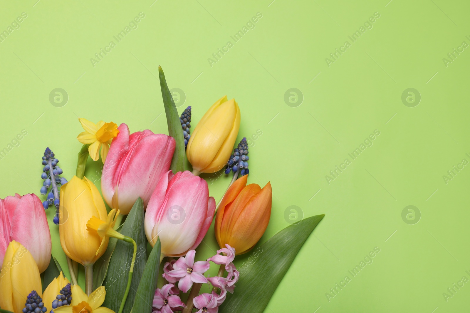 Photo of Beautiful bouquet of different flowers on green background, flat lay. Space for text