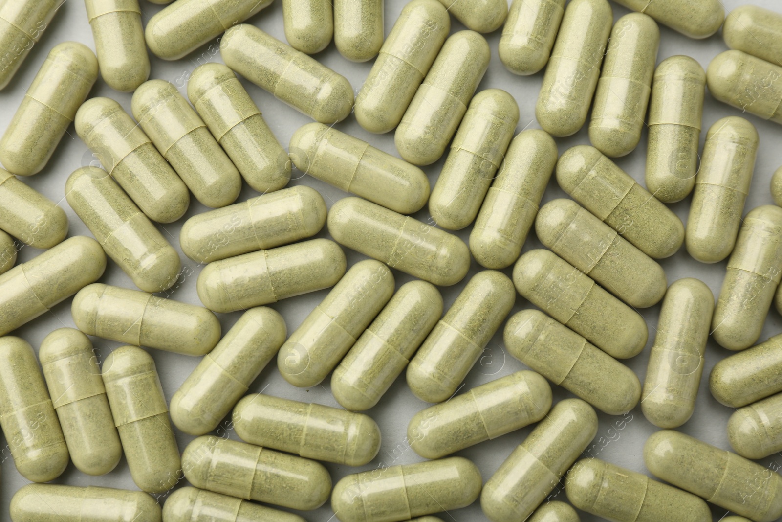 Photo of Vitamin capsules on light grey background, top view. Health supplement