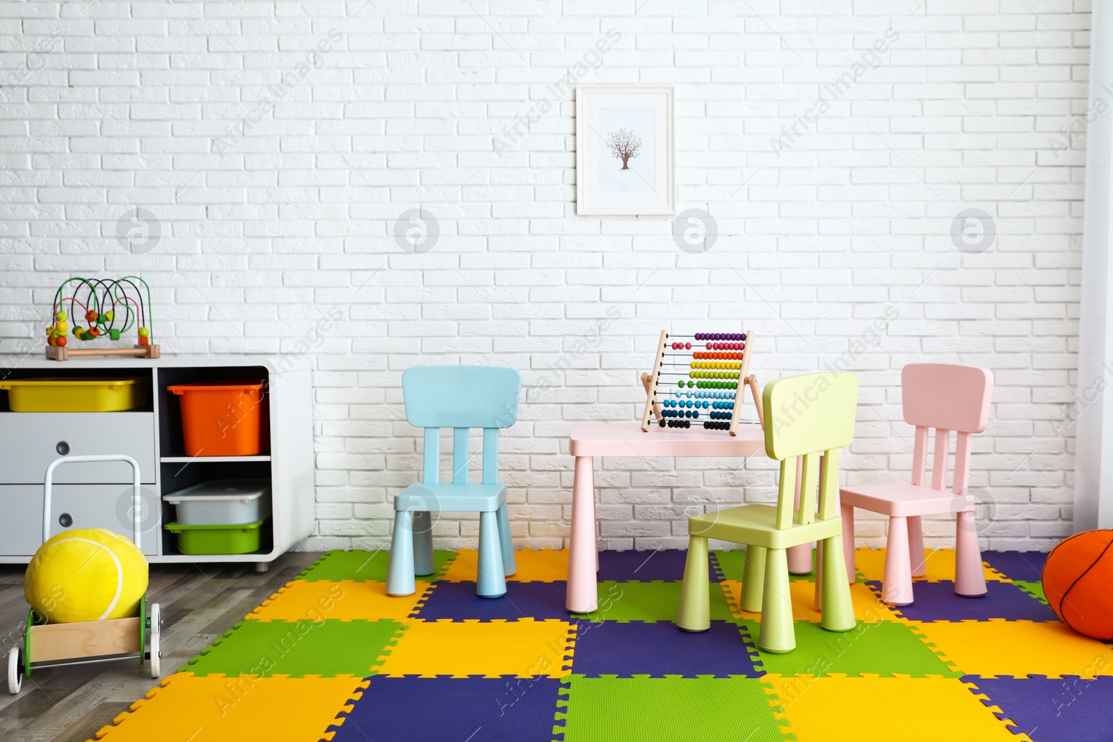 Photo of Stylish playroom interior with toys and modern furniture