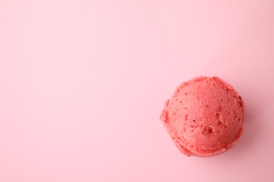 Scoop of delicious strawberry ice cream on pink background, top view. Space for text