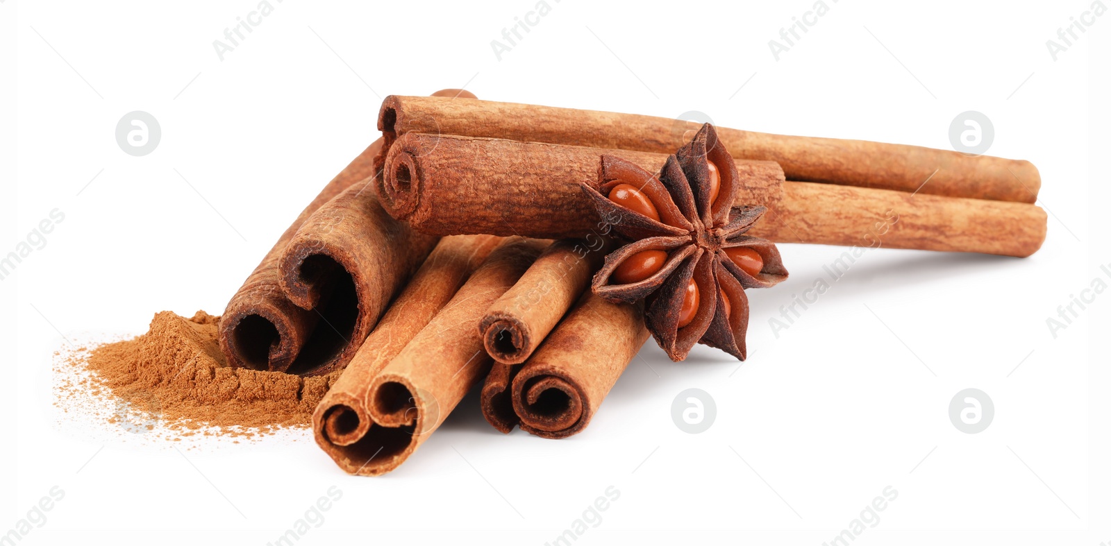 Photo of Dry aromatic cinnamon sticks, powder and anise star isolated on white