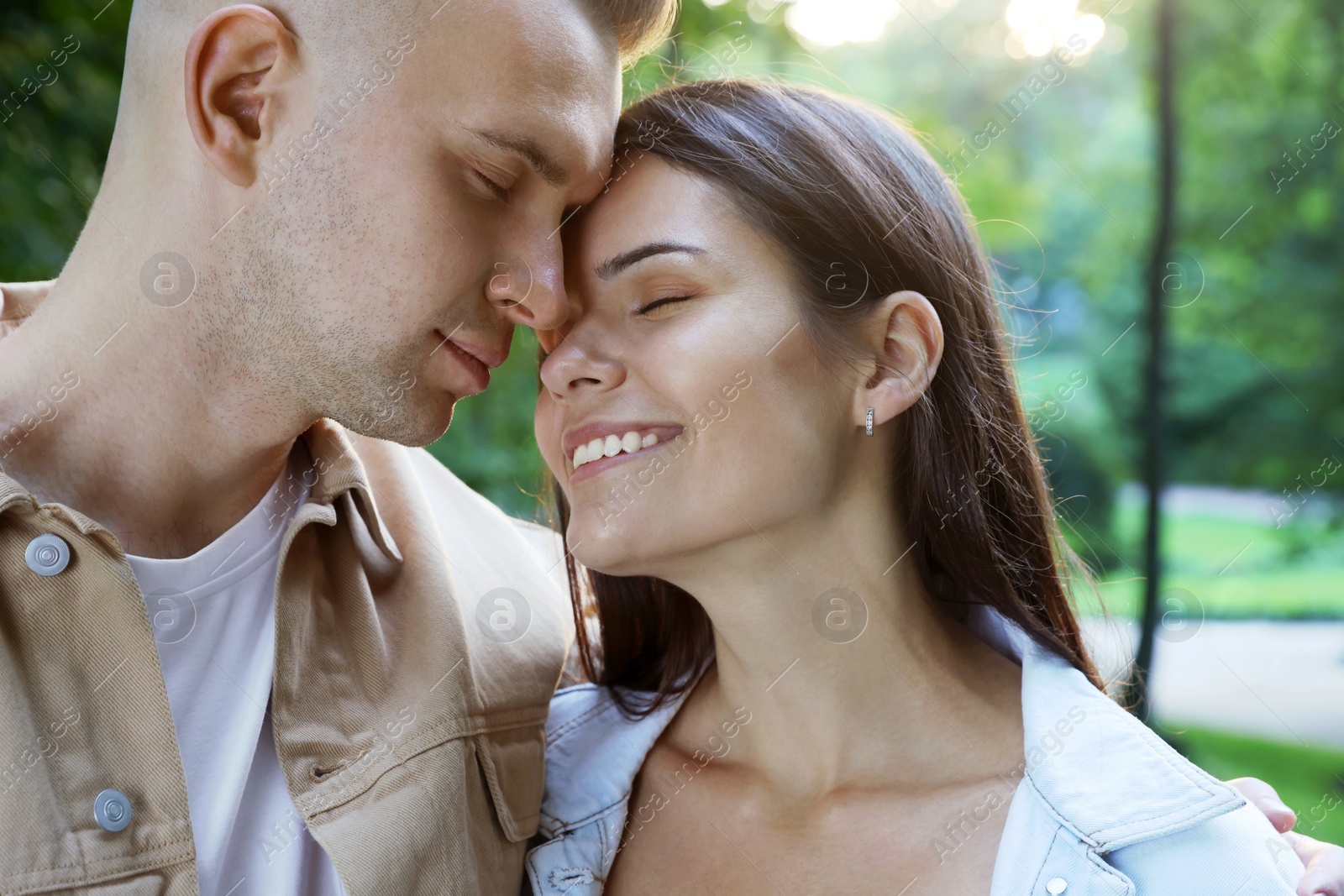 Photo of Happy young couple having good time together in park