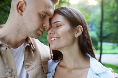 Happy young couple having good time together in park