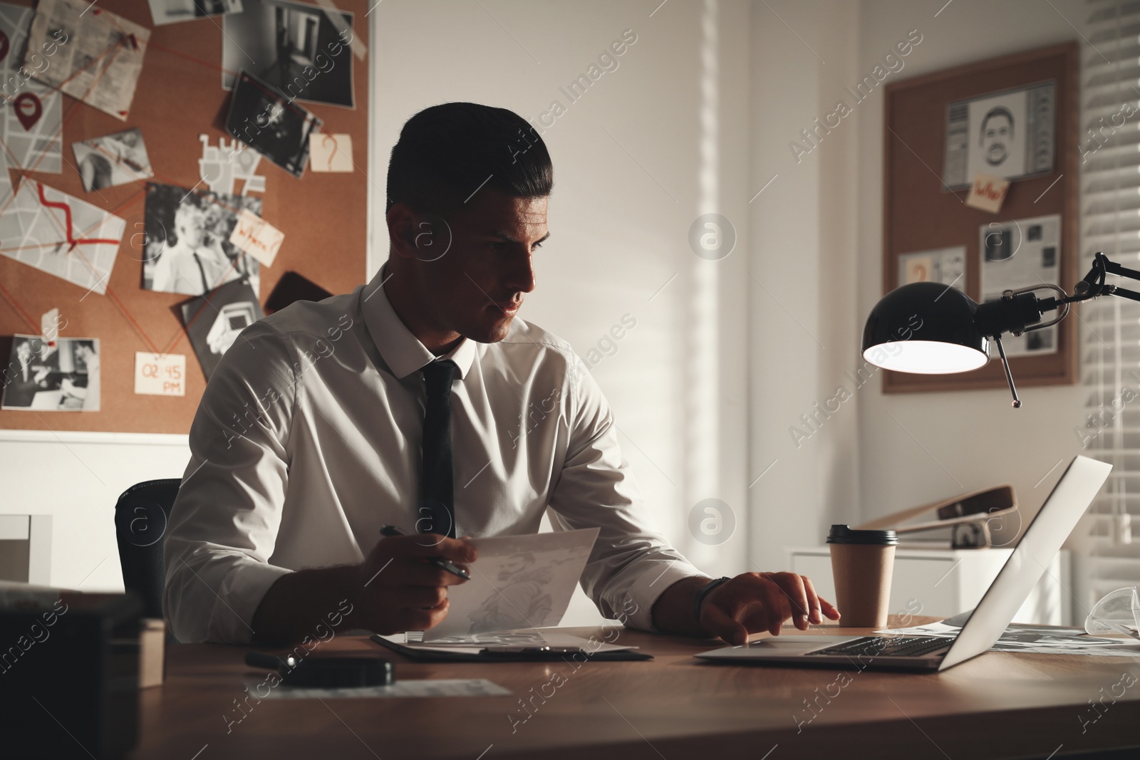 Photo of Detective working at desk in his office