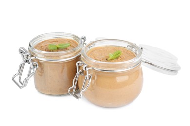 Photo of Glass jars with delicious liver pate on white background