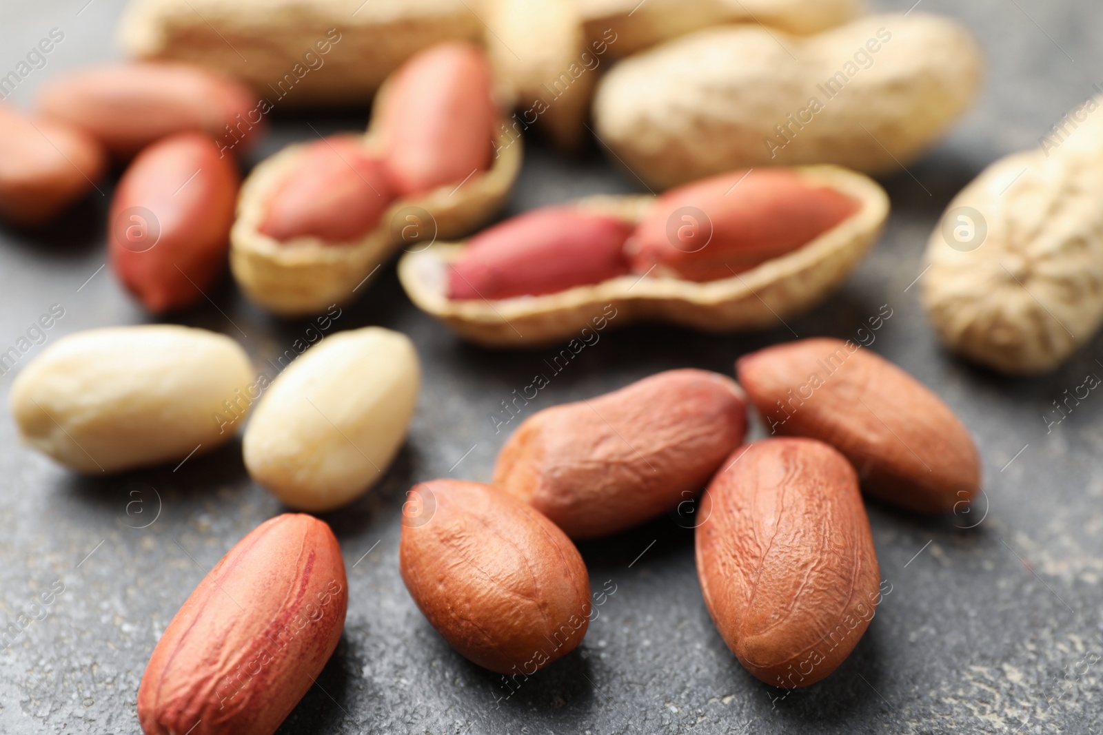 Photo of Fresh peanuts on grey table, closeup view