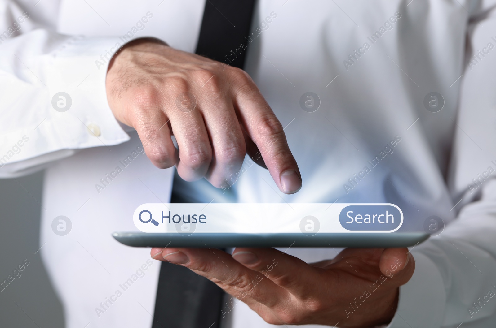 Image of Man using tablet to find house, closeup. Search bar over device