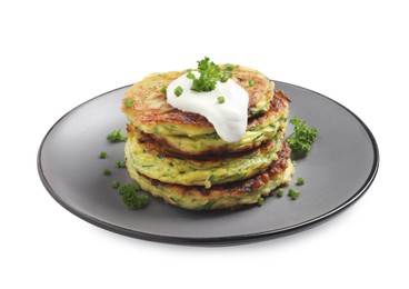 Photo of Delicious zucchini fritters with sour cream isolated on white