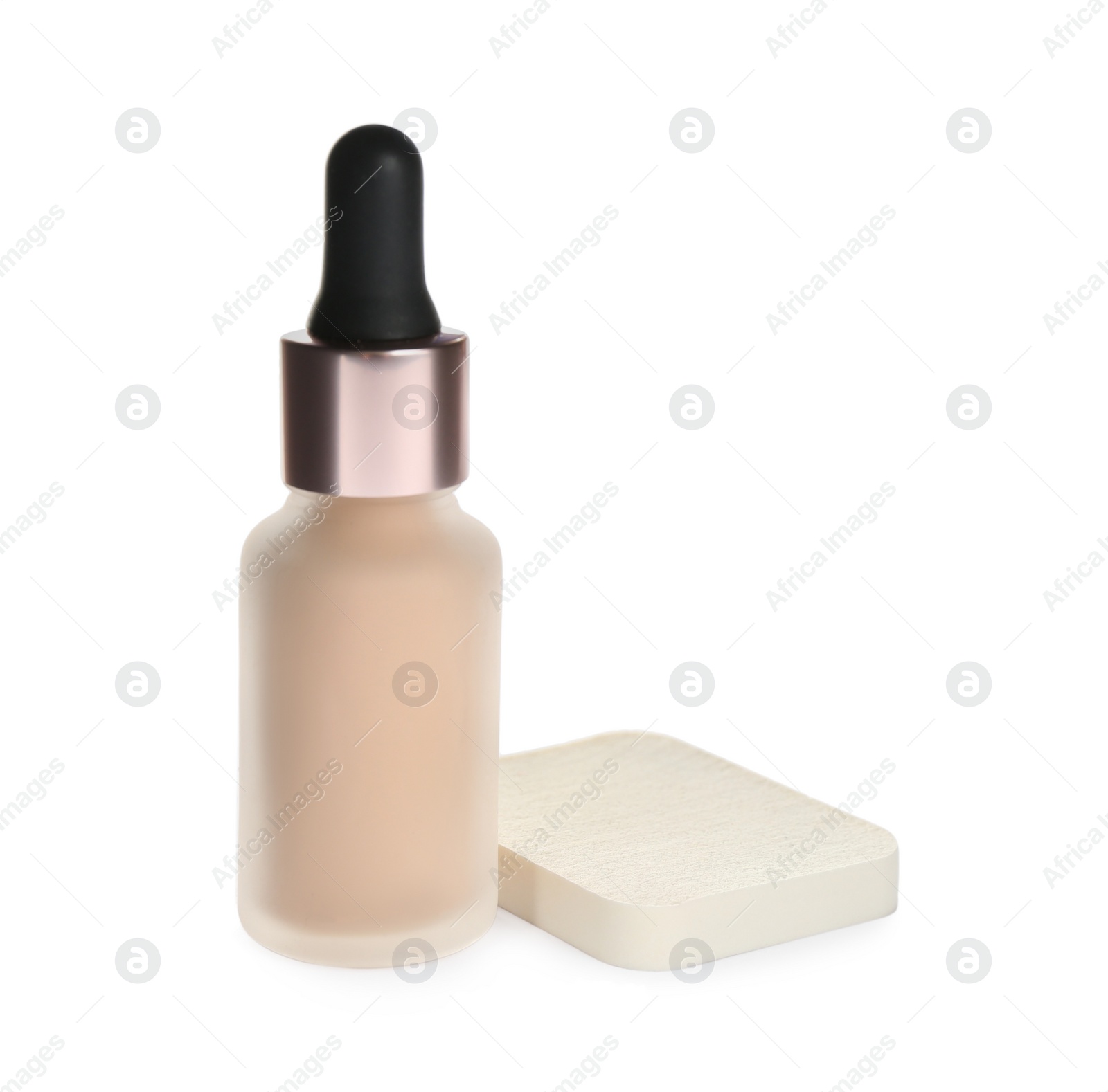 Photo of Bottle of skin foundation with sponge isolated on white. Makeup product