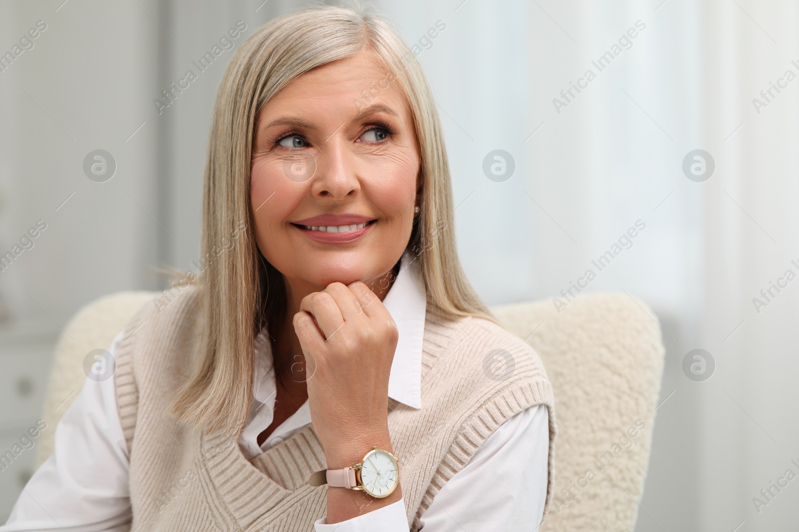 Photo of Portrait of beautiful middle aged woman at home, space for text