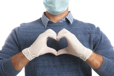 Man in protective face mask and medical gloves making heart with hands on white background, closeup