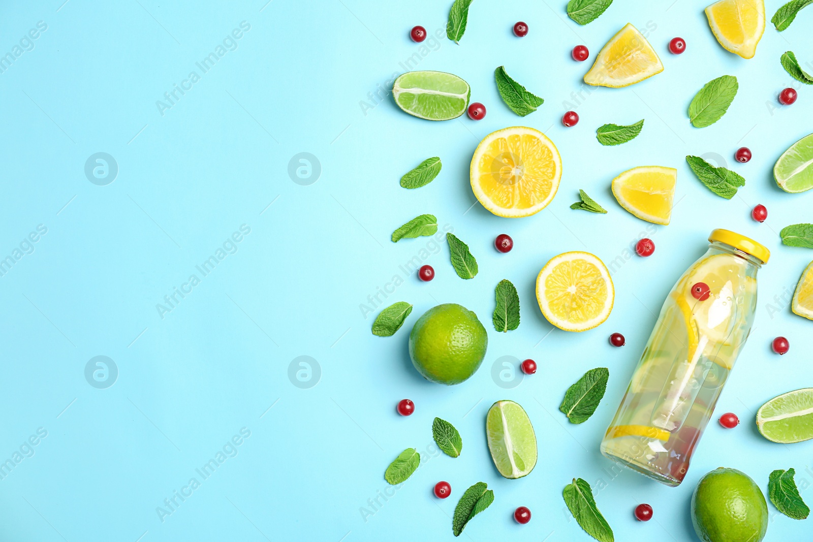 Photo of Flat lay composition with delicious natural lemonade on color background