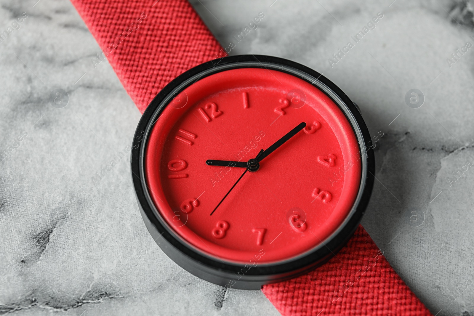 Photo of Stylish wrist watch on marble background, closeup. Fashion accessory