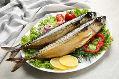 Photo of Tasty smoked fish on light grey marble table