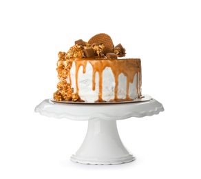 Dessert stand with delicious caramel cake on white background