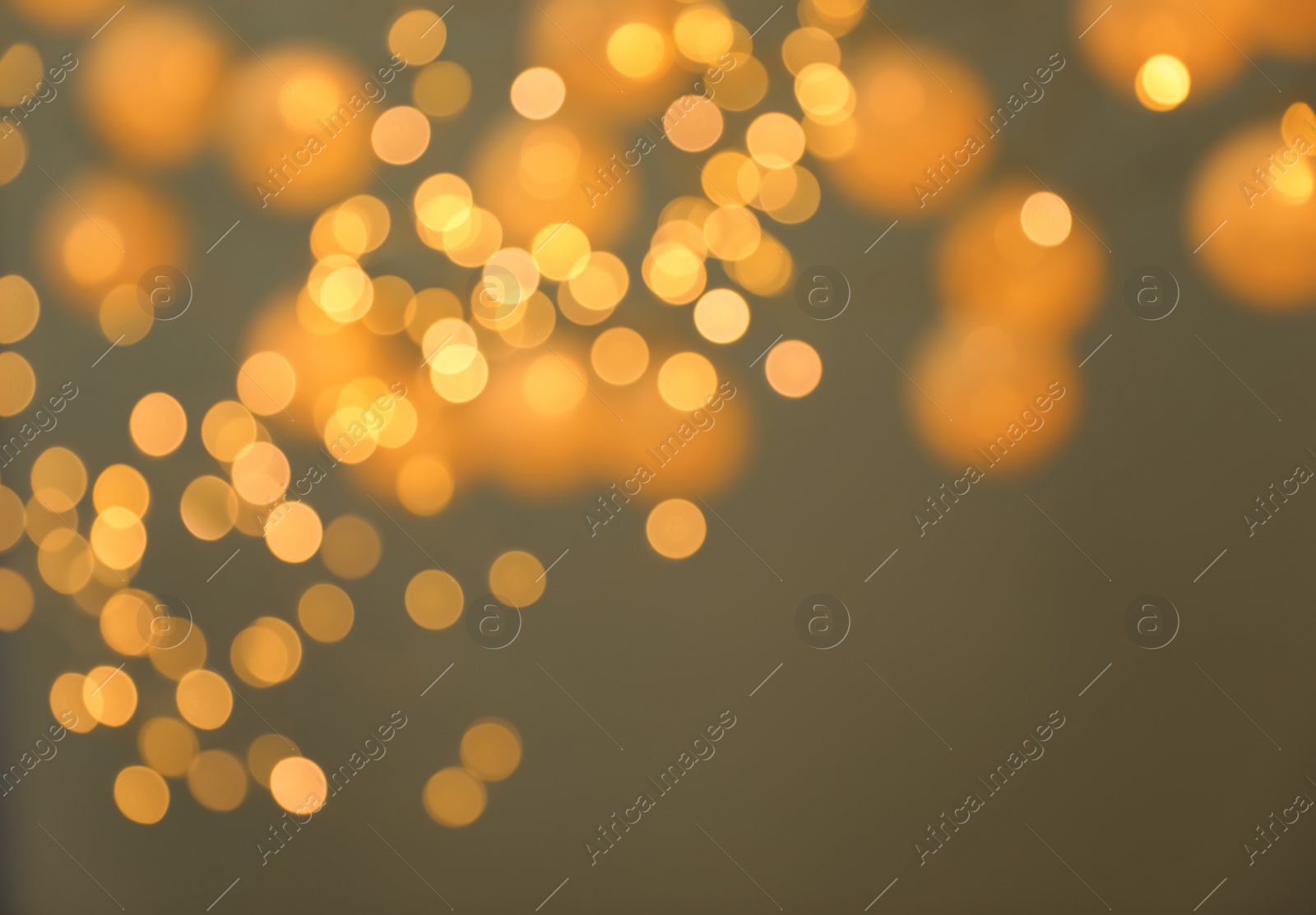 Photo of Blurred view of gold lights on dark background. Bokeh effect