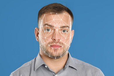 Image of Facial recognition system. Young man with biometric identification scanning grid on light blue background