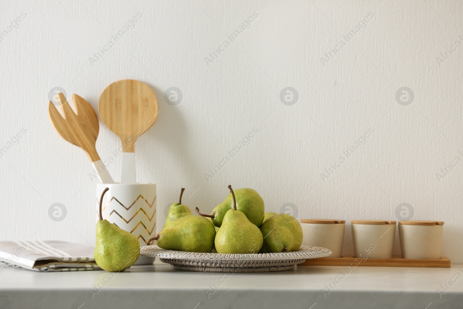 Photo of Plate with fresh ripe pears on white table