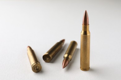 Photo of Bullets on white background, closeup. Space for text