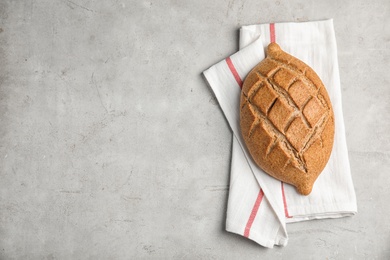 Photo of Fresh bread on grey table, top view. Space for text