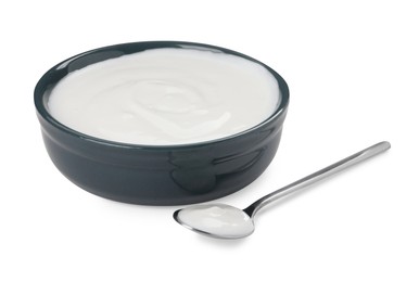 Photo of Bowl and spoon with delicious organic yogurt on white background