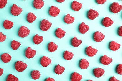 Photo of Flat lay composition with ripe aromatic raspberries on color background