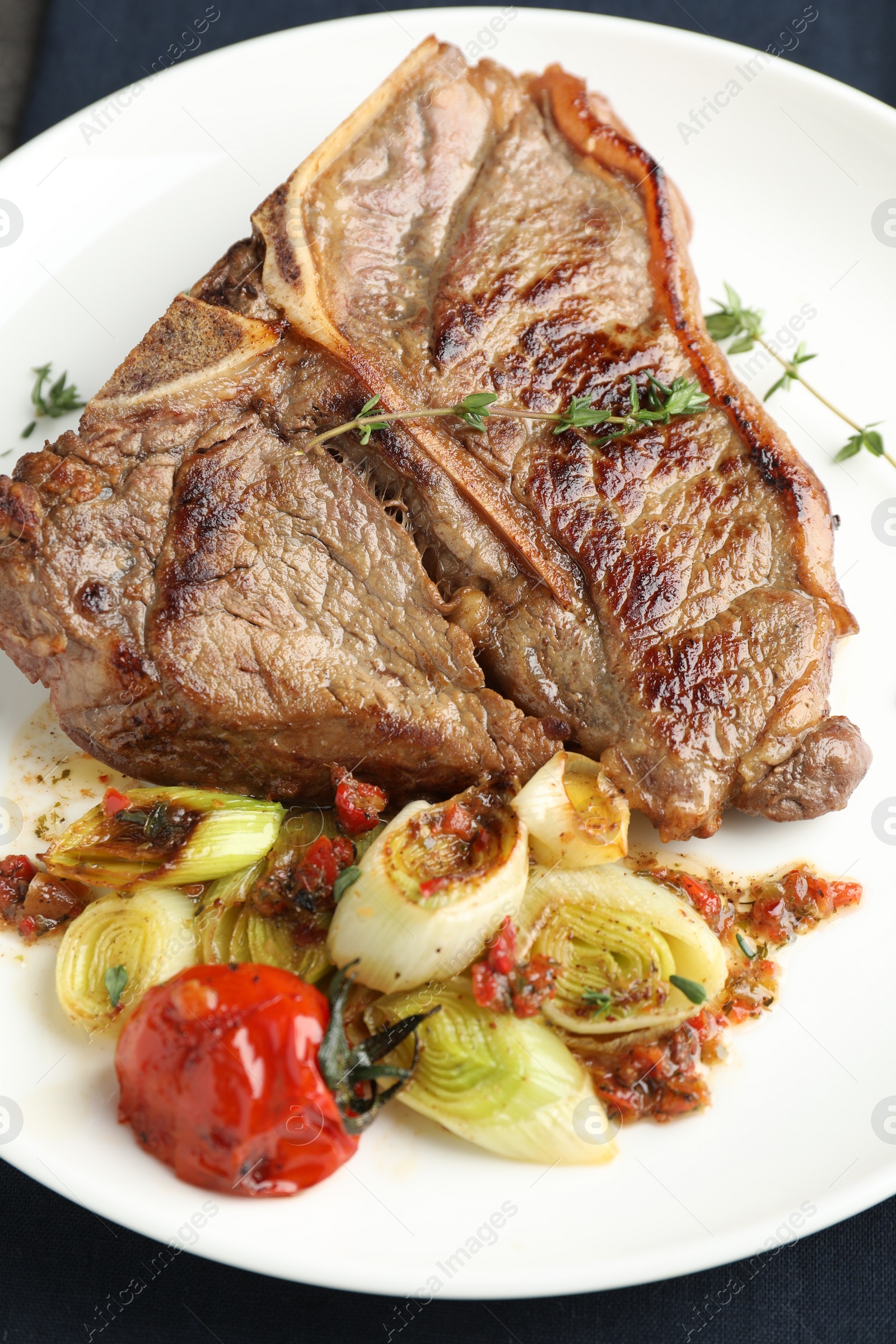 Photo of Delicious fried beef meat and vegetables on table