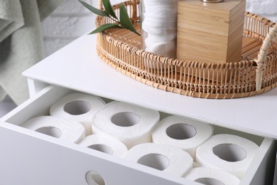 Photo of Many toilet paper rolls in white drawer indoors