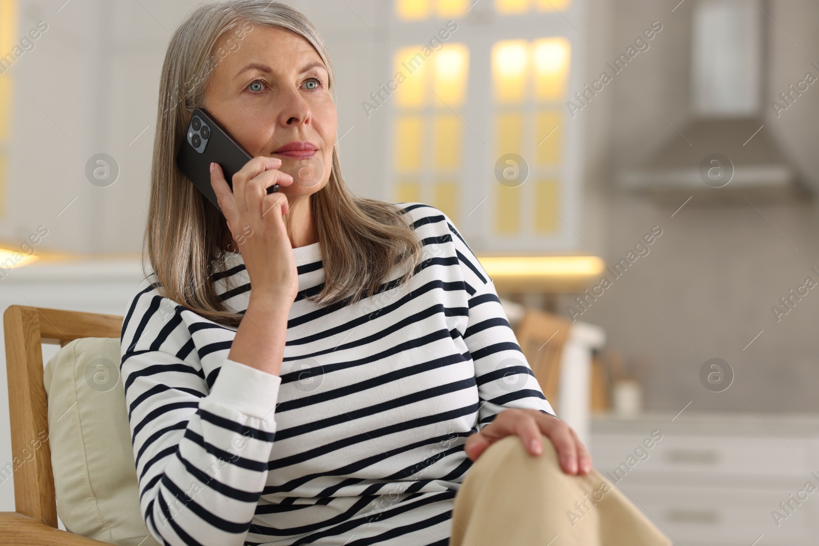 Photo of Senior woman talking on phone at home, space for text