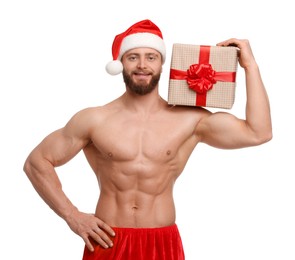 Photo of Attractive young man with muscular body in Santa hat holding Christmas gift box on white background