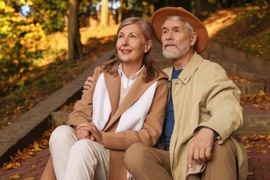 Affectionate senior couple spending time together in autumn park
