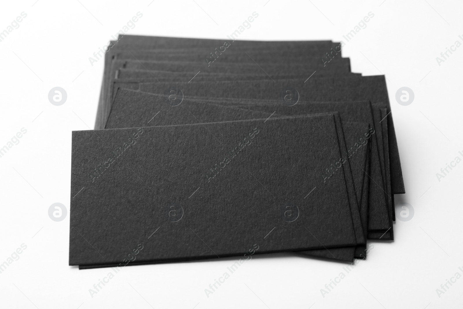 Photo of Blank black business cards on white background, closeup. Mockup for design