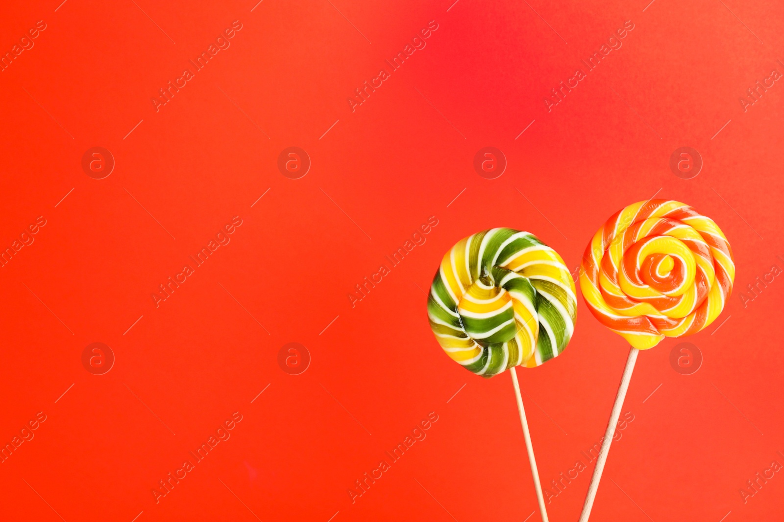 Photo of Bright yummy candies on color background. Space for text