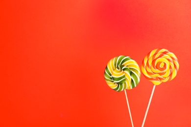 Bright yummy candies on color background. Space for text