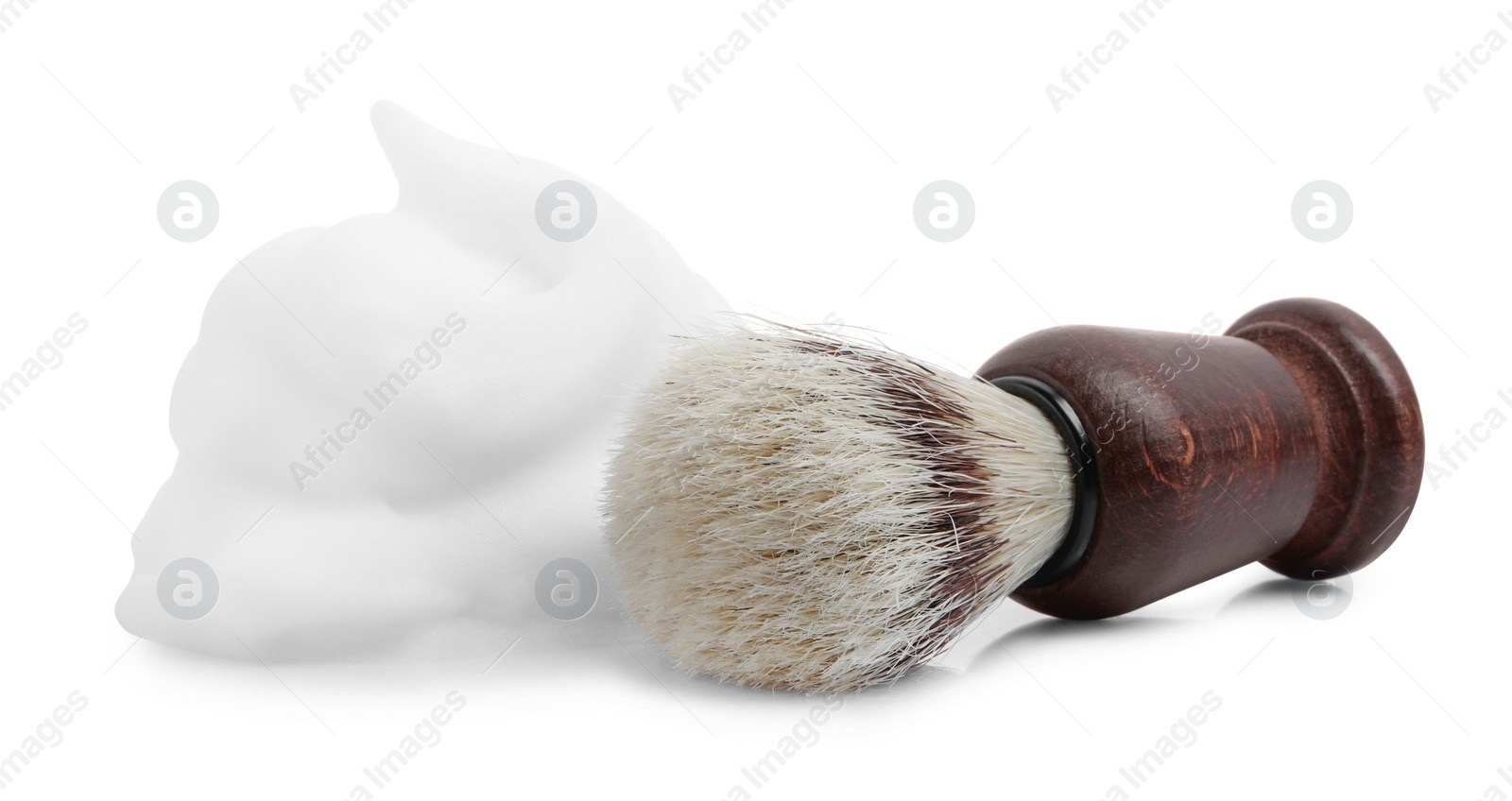 Photo of Shaving foam and brush on white background