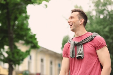 Portrait of attractive young man in stylish outfit outdoors