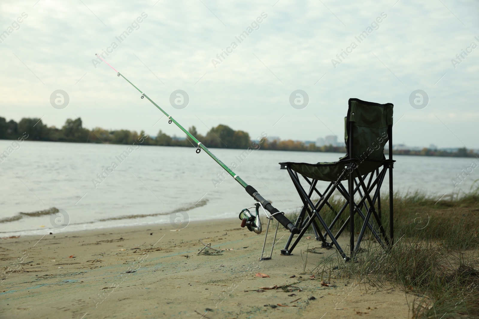 Photo of Folding chairs and fishing rod at riverside