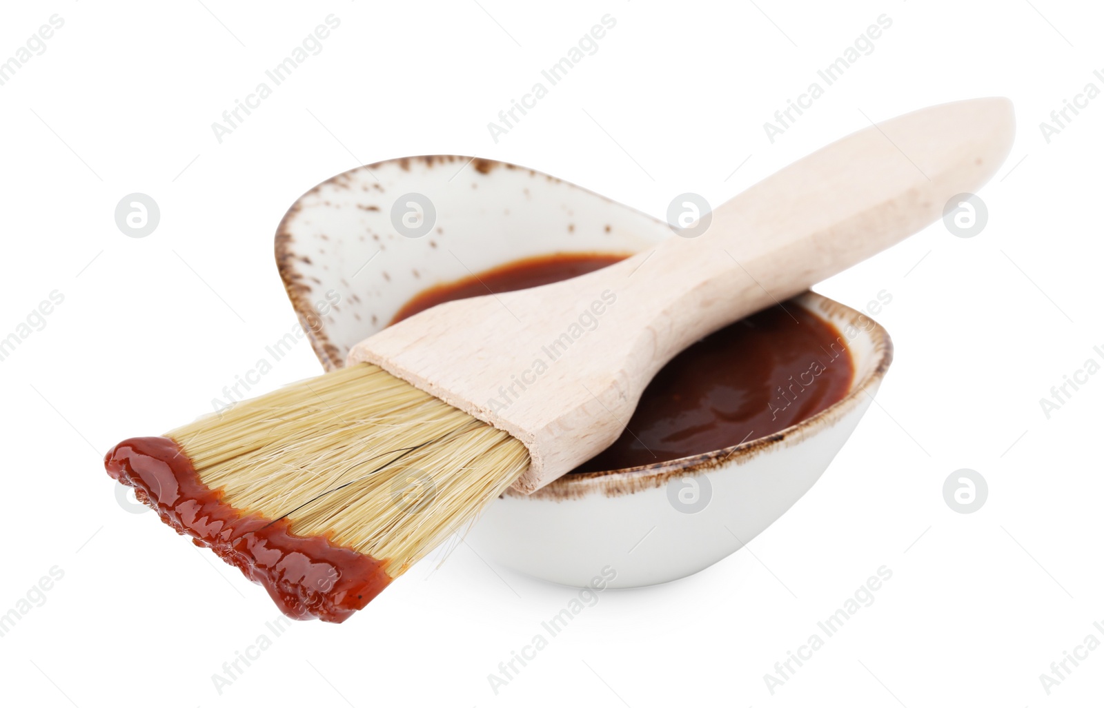 Photo of Marinade in gravy boat and basting brush isolated on white