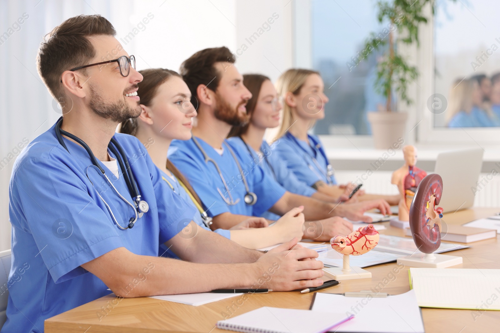 Photo of Medical students in uniforms studying at university