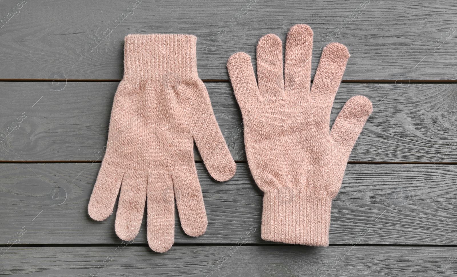 Photo of Stylish gloves on grey wooden background, flat lay